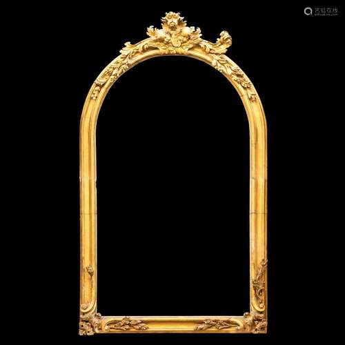 A large carved gilt wood arched frame, 18th century