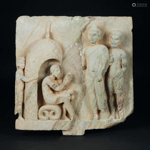 An antique stone fragment in low-relief with 4 figures