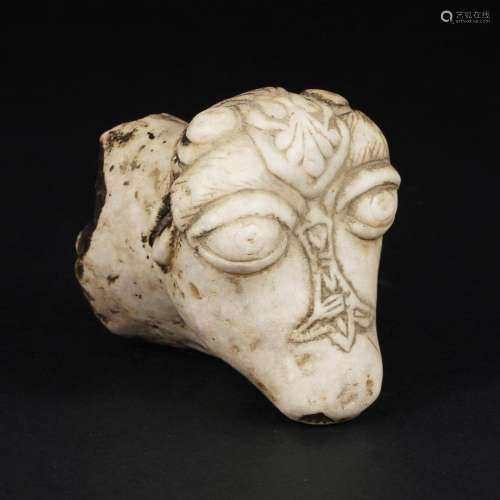 An antique white marble fragment of a horse head, possibly G...