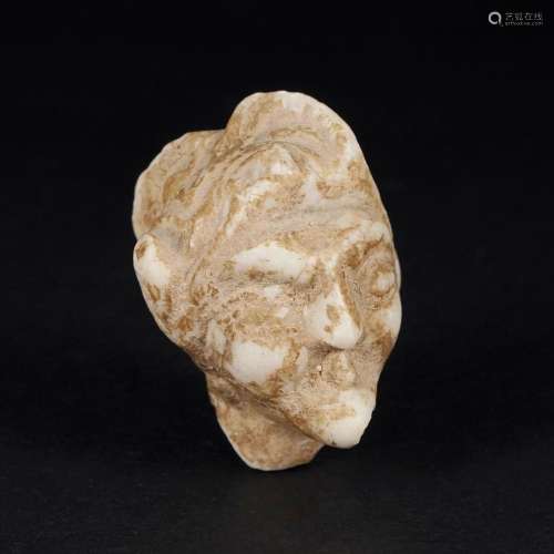 An antique alabaster fragment with the head of a shadok