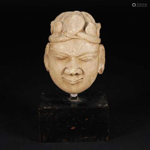 A clay head of a divinity