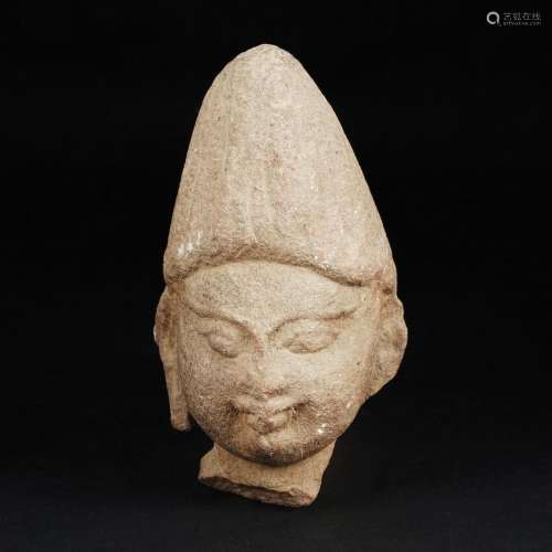 A stone head of Visnu