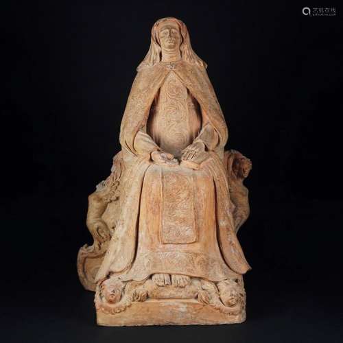 A terracotta figure of a sitting saint, possibly Saint Anne,...