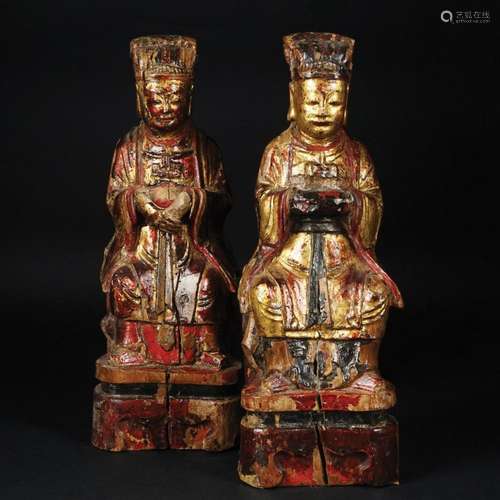 A pair of Chinese polychrome and gilt wood sitting divinitie...