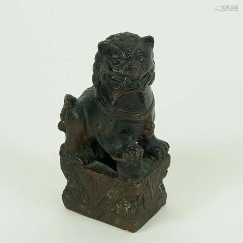 An antique patinated bronze figure of a Foo dog