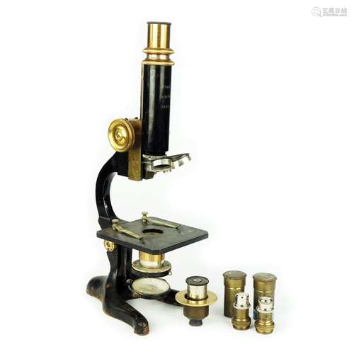 A microscope complete with two ocular lenses and two objecti...