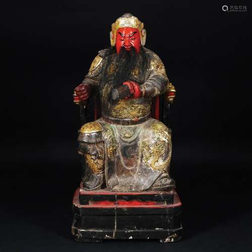 A Chinese lacquered and gilt figure of a sitting emperor wit...