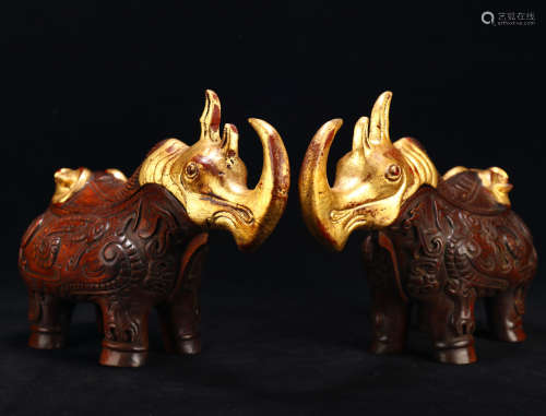 The old collection of agarwood and gold rhino ornaments