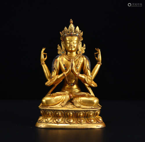 A gilt bronze four-armed Guanyin