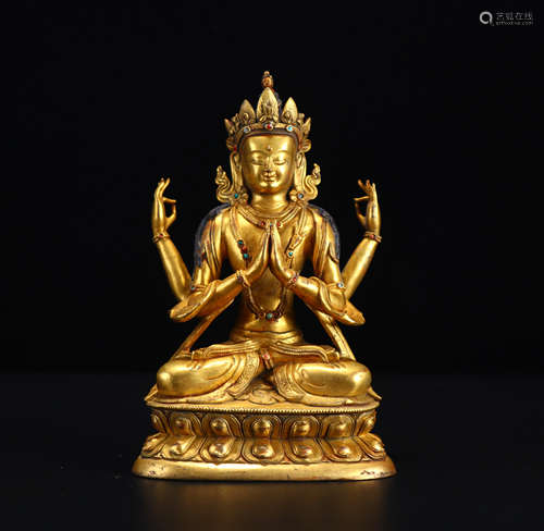 A gilt bronze four-armed Guanyin