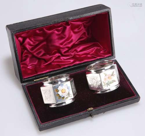 A PAIR OF VICTORIAN SILVER AND ENAMEL NAPKIN RINGS