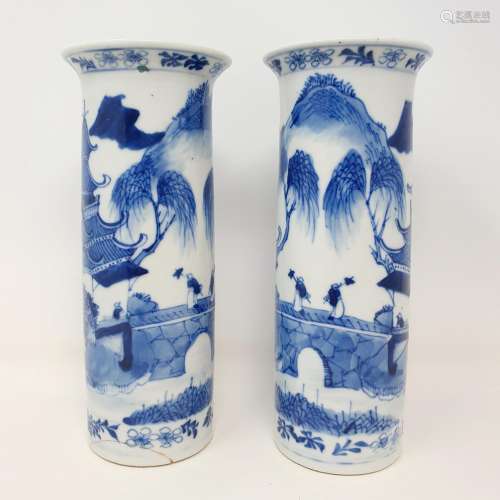 A pair of Chinese blue and white cylinder vases, in undergla...