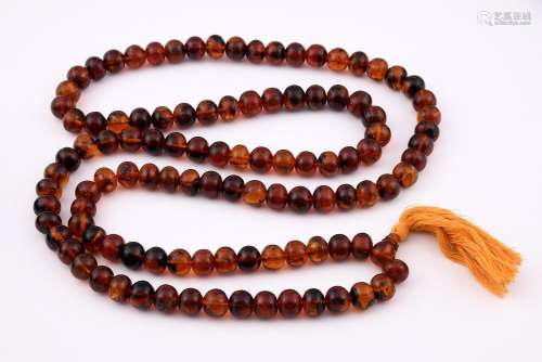An amber bead necklace, 160 cm long approx. Each bead 10 mm ...