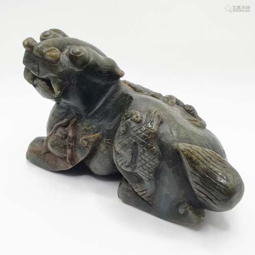 A Chinese carved green stone figure of a lion, 12 cm wide