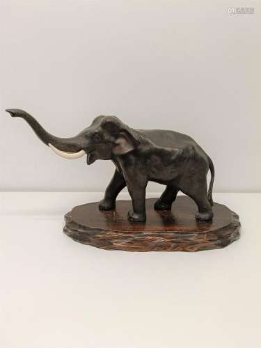 A Japanese bronze elephant, character mark to foot, on a woo...