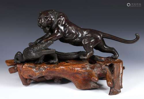 An unusual and large Japanese bronze group, of a tiger attac...