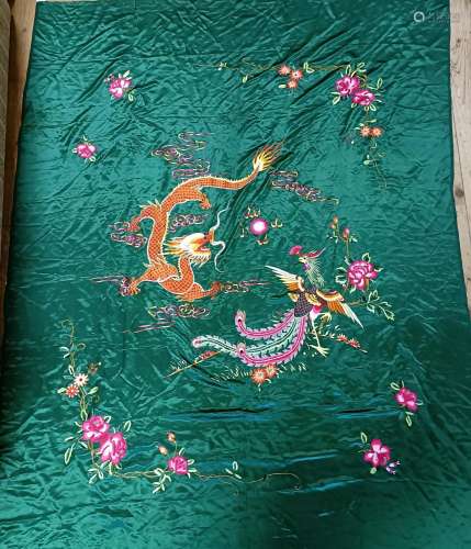 A Chinese silk embroidery, decorated a dragon, on a green gr...