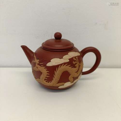 A Chinese red stoneware teapot, decorated dragon, and a phoe...