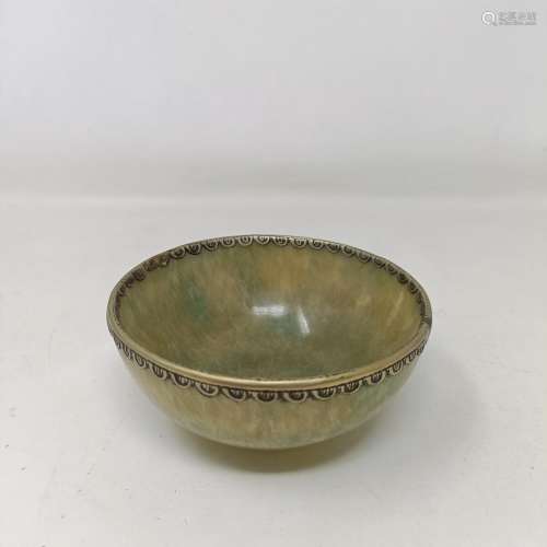 A Chinese carved greenstone bowl, 10 cm diameter