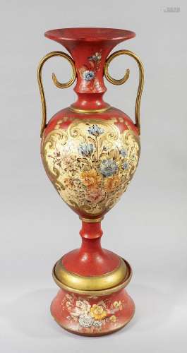 Red vase with handles on a console,