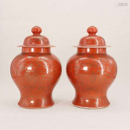 A pair of Chinese coral-ground vases and covers,