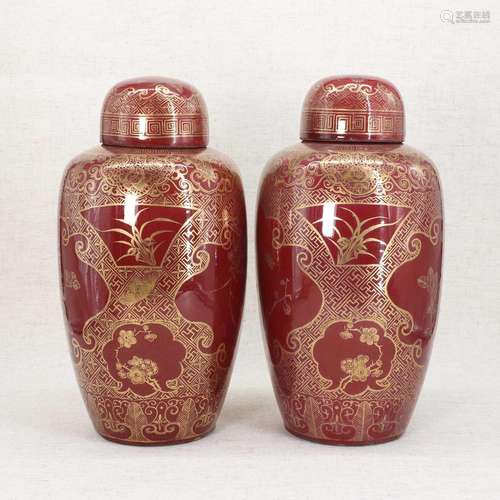 A pair of Chinese sang-de-boeuf vases and covers,