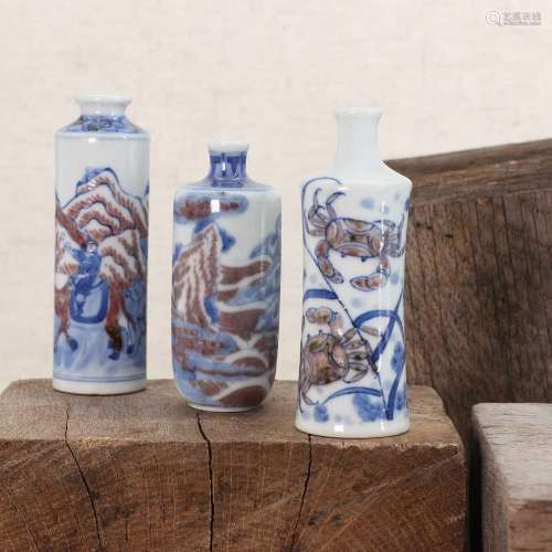 Three Chinese underglaze blue and copper-red porcelain snuff...