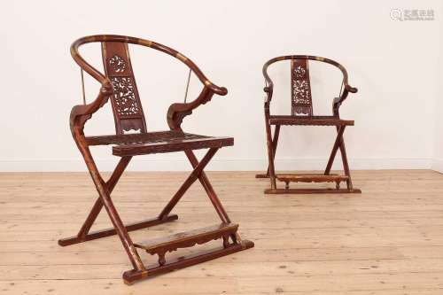 A pair of Chinese hardwood horseshoe-back folding chairs,