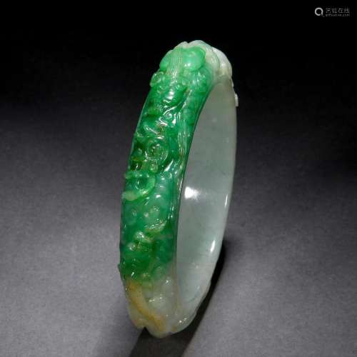 A Chinese Carved Jadeite Bangle