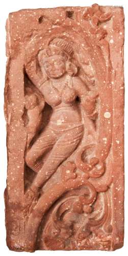 A MOTTLED SANDSTONE RELIEF PANEL OF A DANCING DEITY, INDIA, ...