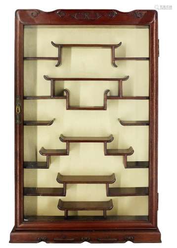 A Chinese wood display cabinet, 20th century, with single gl...