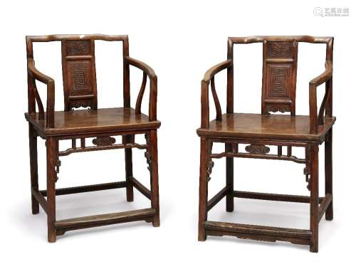 A pair of Chinese walnut armchairs, early 19th century, the ...