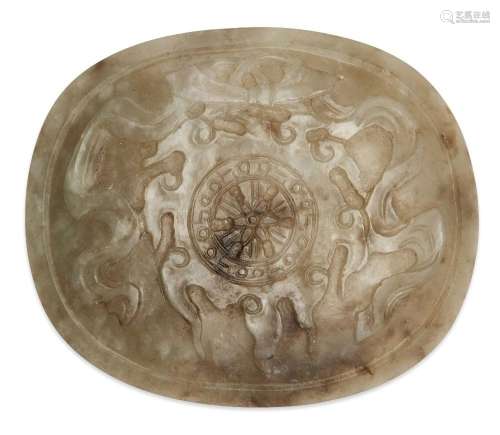 A Chinese celadon and mushroom jade 'wheel of dharma' oval p...