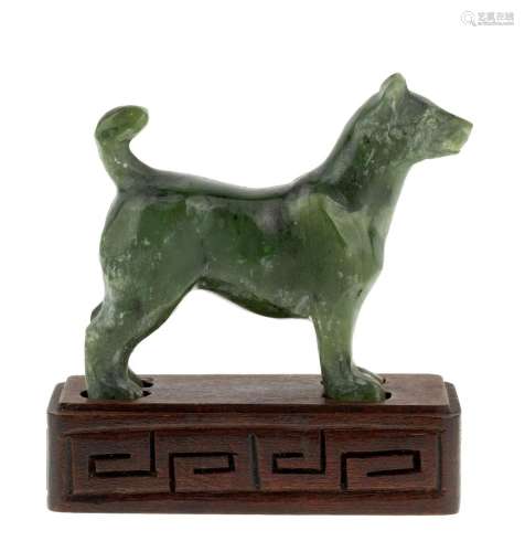 A Chinese spinach jade carved standing dog, early 20th centu...