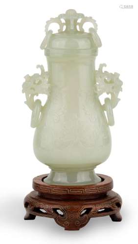 A Chinese celadon jade twin-handled vase and cover, late Qin...