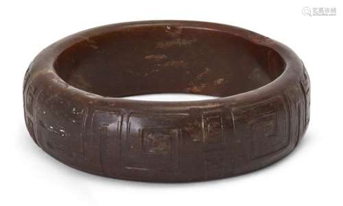 A Chinese russet jade archaistic bangle, Qing Dynasty, carve...