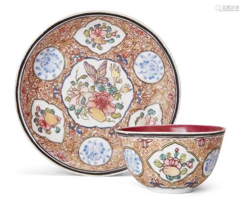 A Chinese famille rose ruby ground teacup and saucer, Yongzh...