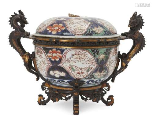 A large Japanese gilt bronze mounted Imari bowl and cover, 1...
