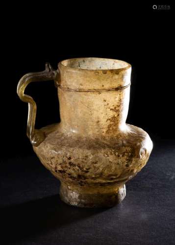 A RARE FATIMID CLEAR GLASS LUSTRE HANDLED GLASS JUG, 10TH CE...