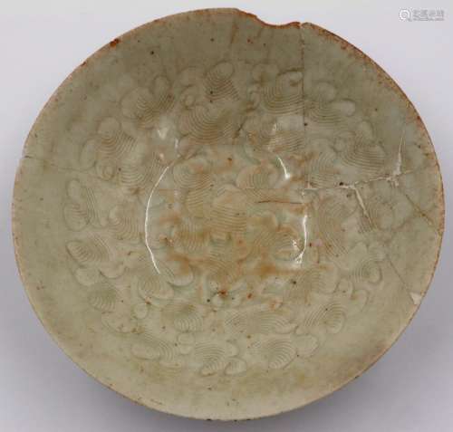 A celadon glazed porcelain bowl having incised decoration to...