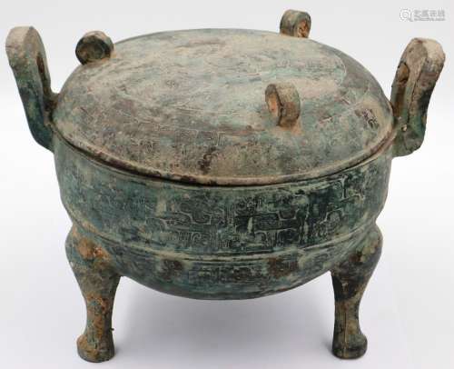 An archaic Shang Dynasty ritual bronze food vessel and cover...