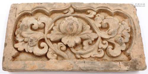 A Song Dynasty grey clay tile, decorated in high relief with...