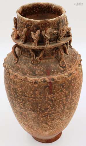 A Tang Dynasty funerary urn, having applied figures and beas...