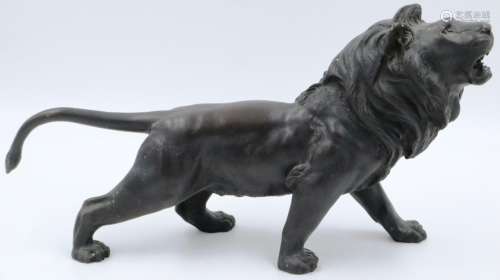 A Japanese Meiji period cast bronze figure of a lion, with i...