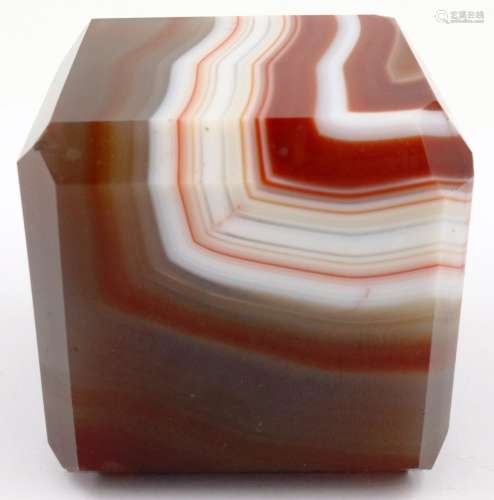 A heavily banded polished chuyu red agate cube, having chamf...