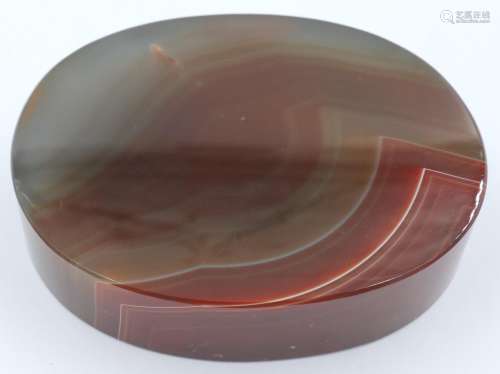 A banded oval block of chuyu red agate, 9 x 7 x 2 cm H. P&am...