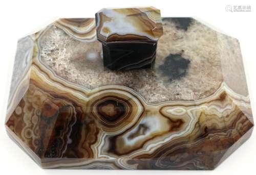 A banded and heavily laced brown manao agate paperweight, be...
