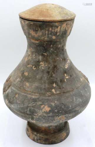 A Han Dynasty covered jar or Hu, thrown in grey clay with mo...