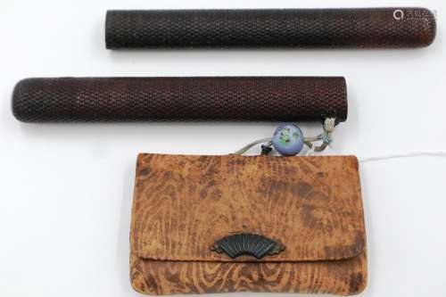 A Japanese Meiji period leather tobacco pouch mounted with a...