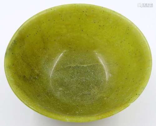 A Chinese carved jade or similar bowl, D: 12 cm, H: 5 cm. Sm...